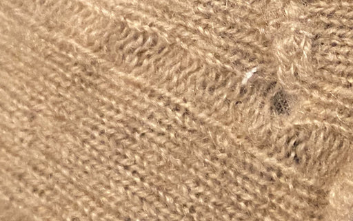 cashmere wool with holes caused by moth larvae