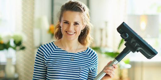 A woman getting rid of a moth larvae infestation in her home, using moth prevention methods to get rid of them. 