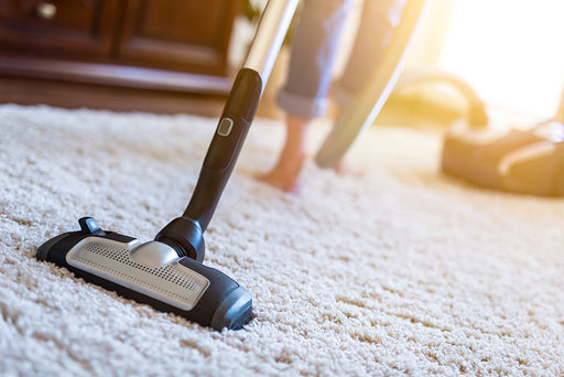 a close up of a vacuum cleaner on a woolen carpet