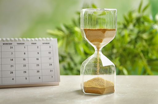 an hourglass next to a calendar