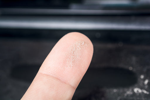 a finger with dust on it