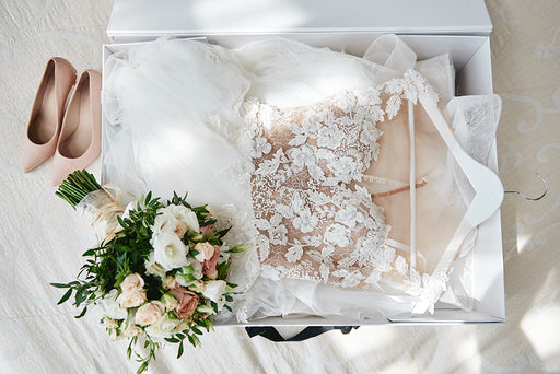 a wedding dress lying in white tissue paper