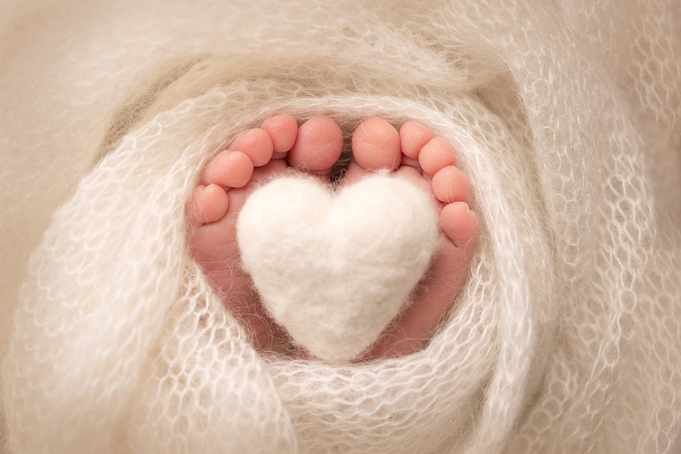 a baby’s feet wrapped in soft wool