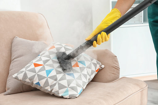a couch with cushions being steam cleaned