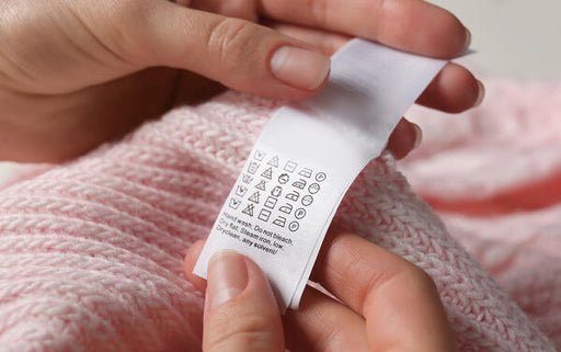 checking the hand wash care label on delicate fabric