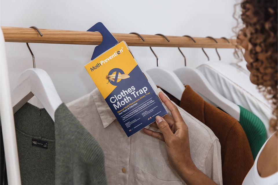 Moth Prevention Clothes and Carpet Moth Trap being hung on a clothes rail