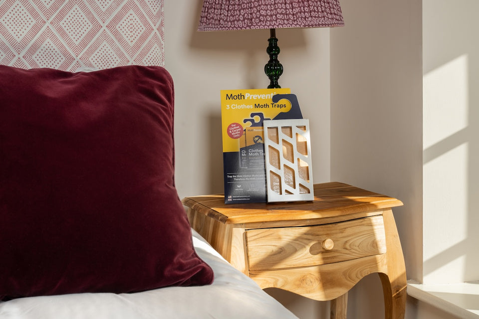 a MothPrevention Clothes Moth Trap on a bedside table