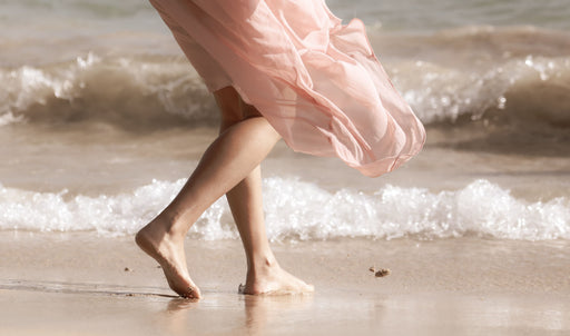 walking on the beach in a silk skirt billowed by the wind