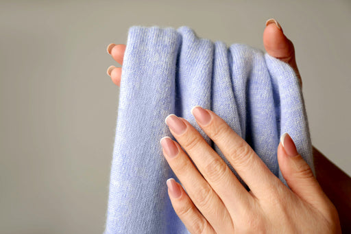 hands holding cashmere material