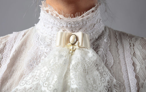 intricate victorian lace on the neck of a dress