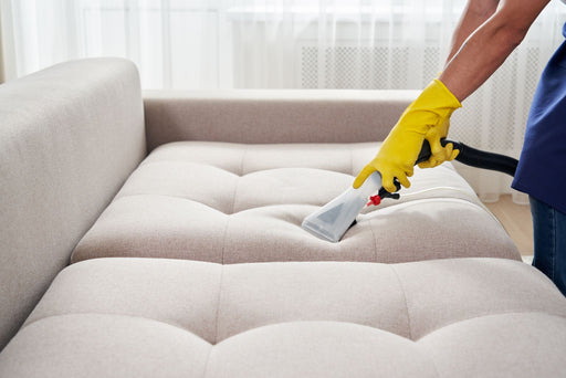 a wet-vac being used to clean a couch